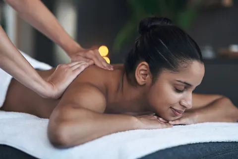 Shot of a young woman getting a back massage at a spa.